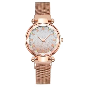 Detail of rose gold ladies watch with magnetic mesh strap and starburst glitter dial