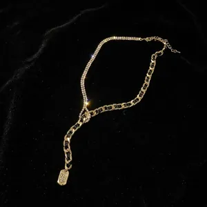 Exaggerated gold curb chain necklace with rhinestone detail and rectangle pendant