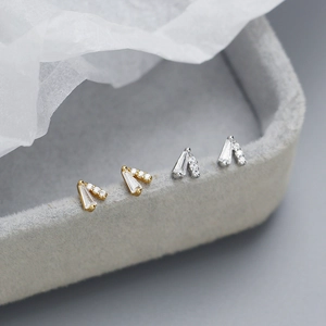 Elegant S925 silver V-shaped stud earrings with sparkling cubic zirconia on gray velvet