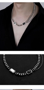 Detail of double-layer silver curb chain necklace with black and white geometric accents