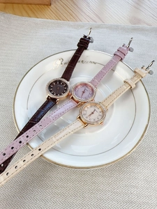 Detailed macro view of three vintage-style leather watches on a white decorative plate
