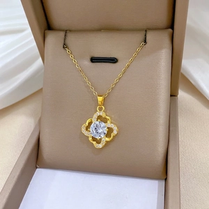 Elegant gold hollow flower necklace with shimmering rhinestones on a white silk background