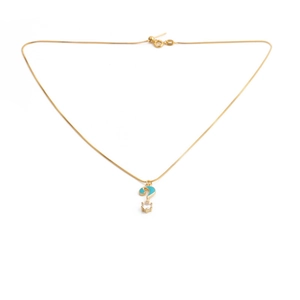Detail of gold-plated necklace featuring a blue enamel question mark pendant with crystal
