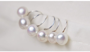 Detailed macro view of high luster 8-9mm natural freshwater pearls on s925 silver hooks