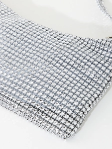 Detailed macro view of sparkling silver rhinestones on luxury evening shoulder bag