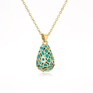 Macro detail of teardrop 18K gold plated necklace with blue and white evil eye charms