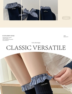 Detail of navy blue cotton socks with lace ruffles, bow accents and soft texture