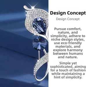 Macro detail of leaf-shaped brooch with blue crystals and pavé-set sparkling diamonds