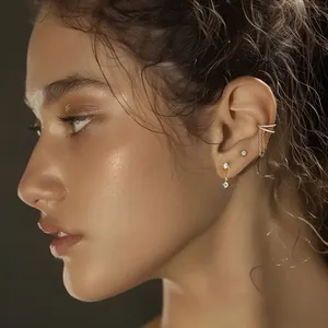 Detail view of 925 silver gold-plated earring set with zircon and tassel chain on model