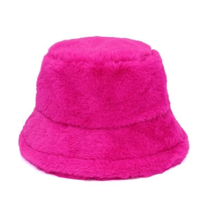 Close-up of plush rose red faux fur texture on a warm winter bucket hat for women