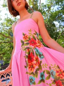 Detailed close-up of vibrant floral print on a summer backless strap dress in pink fabric