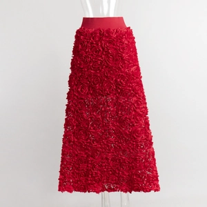 Detail of vibrant red 3D rose petal appliqués on the elegant evening maxi skirt