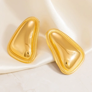 Minimalist irregular golden flower petal earrings on beige silk background for women