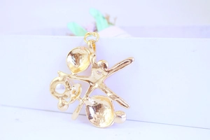 Macro detail of golden starfish keychain charm with textured metallic surface and luster