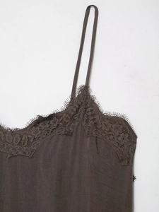 Close-up of dark brown lace trim and silky fabric on a minimalist camisole top