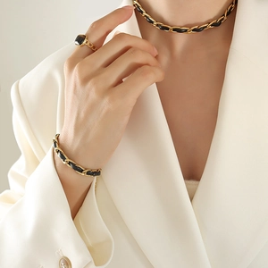Ensemble bijoux en cuir tressé avec collier doré et bague sertie d'une pierre noire