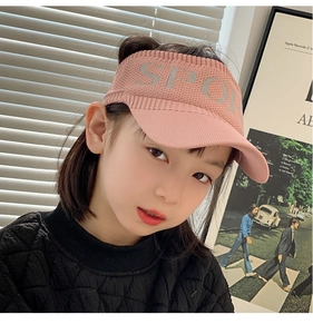 Detail of pink knitted visor hat for kids with SPORT logo for outdoor activities