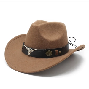 Close-up of brown felt cowboy hat featuring black leather band and silver bull head decor