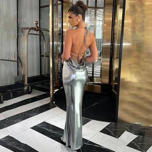 Detailed back view of a slim fit silver metallic backless maxi dress with cross straps