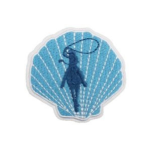 Shell shaped blue embroidery patch with detailed white border for clothing decoration