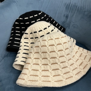 Three-color knit bucket hats in black, beige, and striped brown for winter warmth