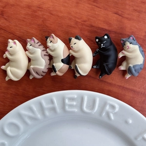 Detail showing six colorful miniature resin cat figurines with different fur patterns