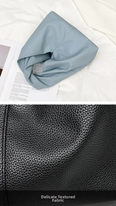 Macro shot of grainy texture and soft PU fabric on minimalist triangle cloud bags