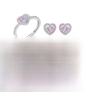 Macro detail of S925 sterling silver heart ring and studs set with pink zircon