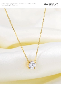 Detail of a four-prong set round zircon pendant on a gold titanium steel necklace
