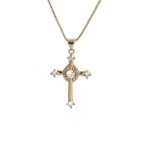 Close-up of golden cross pendant necklace with sparkling white zircon stones