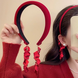 Detail of red velvet headband with long floral tassel earrings in ethnic style design
