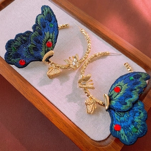 Retro embroidered butterfly hoop earrings with teal gradient wings and luxury gold finish