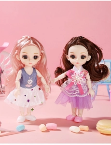 Detailed view of two princess dolls with pink and brown hair in stylish dresses