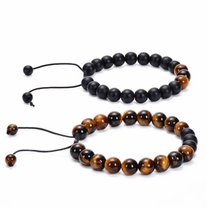 Close-up of handmade red tiger eye and matte black beaded bracelets with adjustable cord