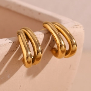 Macro view of double-layered gold U-shaped earrings with high-polished stainless steel finish