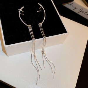 Detail view of silver moon star tassel ear cuff with sparkling zircon and long fringes