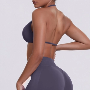 Close-up of seamless dark purple sports bra and high-waisted leggings with open back detail