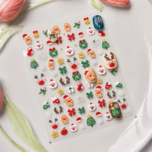 Close-up of 3D embossed Christmas nail stickers with Santa, reindeer and tree patterns