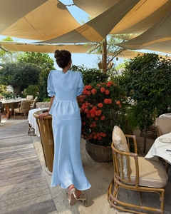 Detail of light blue linen two-piece set featuring puff sleeves and fishtail skirt back
