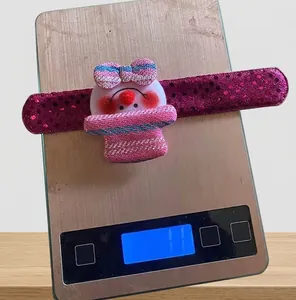 Detailed view of snowman slap bracelet with pink sequins weighing 11g on scale