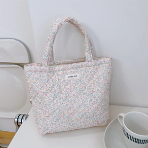 Detailed close-up of quilted floral cotton fabric texture and Simple Wish label