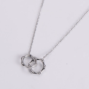 Detailed view of silver bamboo texture interlocking double rings on a delicate O-chain