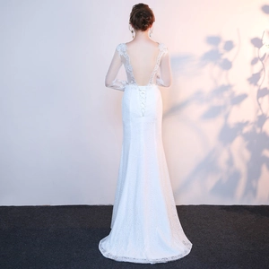 Detailed back view of lace fishtail wedding dress with long sleeves and open back design