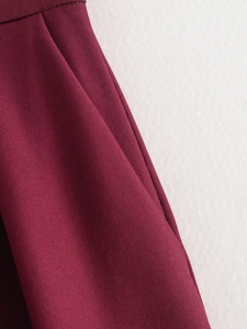 Detailed macro view of red twill fabric texture and stitching on vintage style jacket