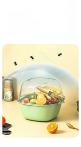 Close-up of dual-layer green drain basket with clear dome cover for washing fruits
