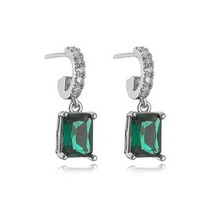 Detail of silver drop earrings featuring emerald rectangular stone and white crystals