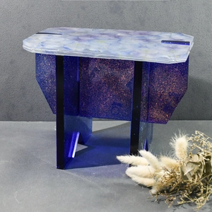 Detail of DIY epoxy resin mold kit showing blue glitter bench with embedded floral top