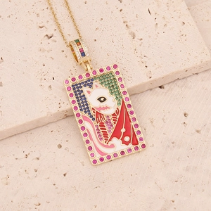 Detail of 18K gold-plated tarot pendant with fox mask enamel and colorful gemstones