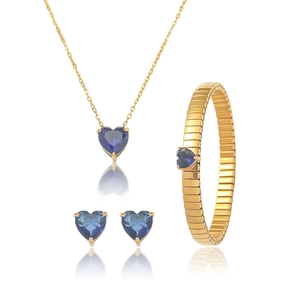 Detail of gold heart jewelry set featuring sapphire blue zircons and link bracelet