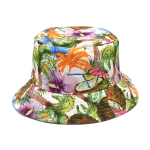 Detailed view of tropical print bucket hat with palm trees, flowers, and coconut patterns